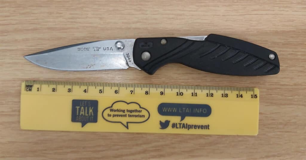 Police photo showing an illegal lock knife next to a ruler.